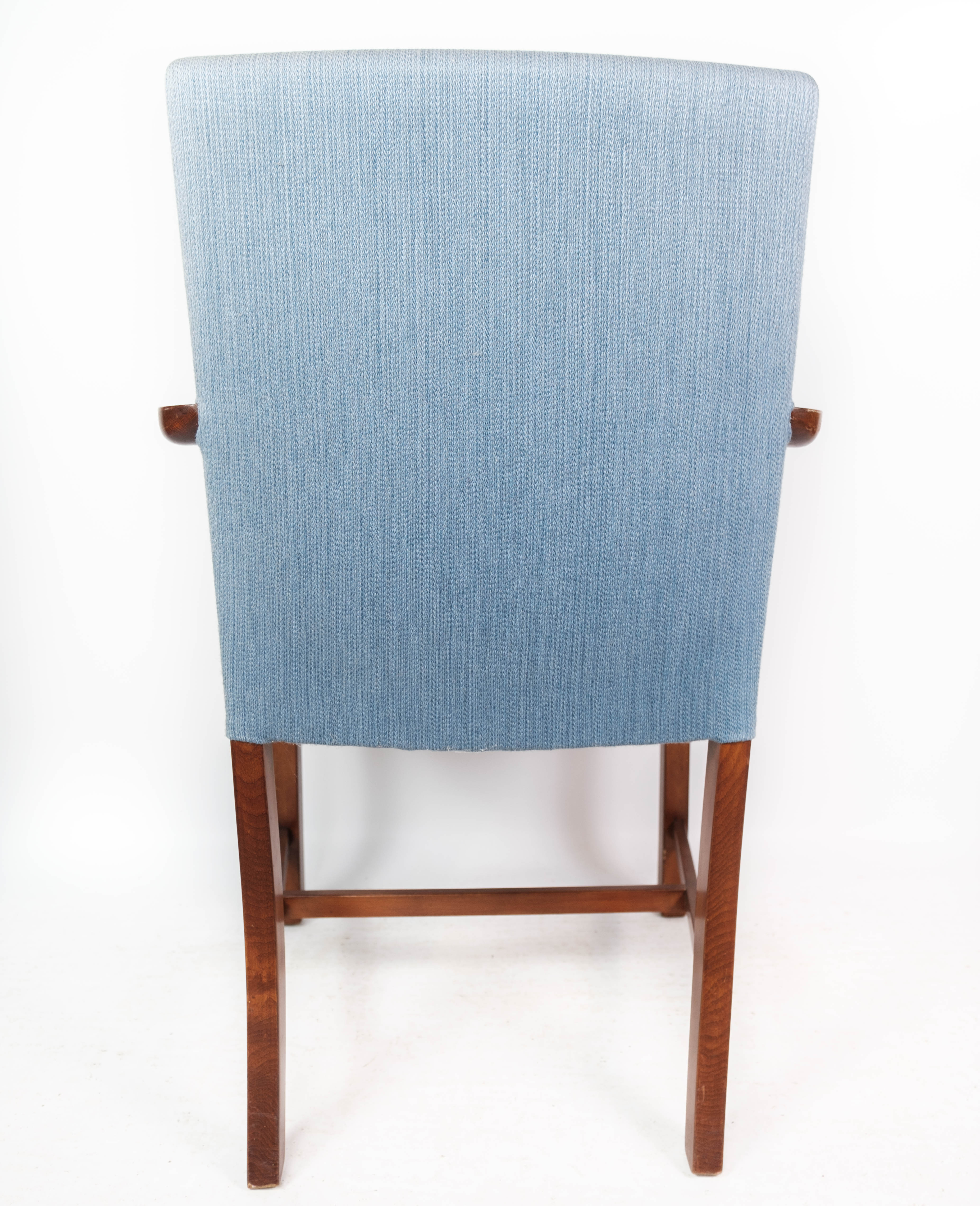 Armchair in mahogany and upholstered with light blue fabric by Fritz Hansen