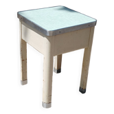 Shoe polish stool with round top and aluminum legs.