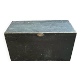 Trunk, black wooden chest and wallpaper