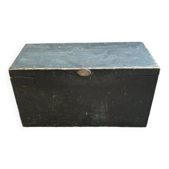 Trunk, black wooden chest and wallpaper