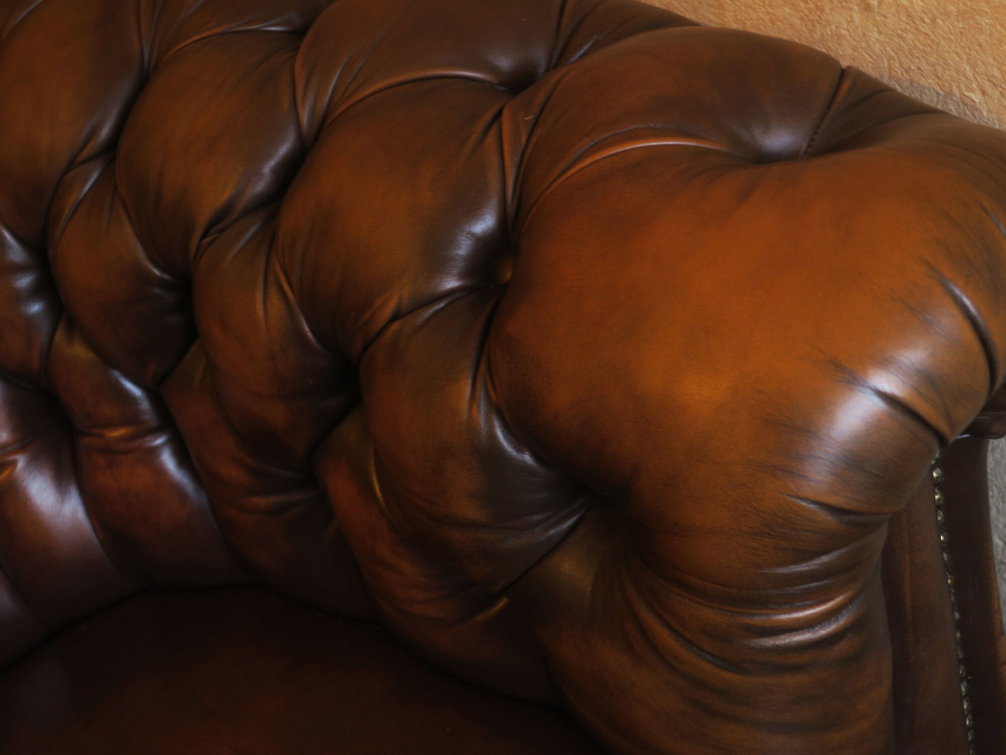 Chesterfield club armchair in patinated chestnut coloured leather