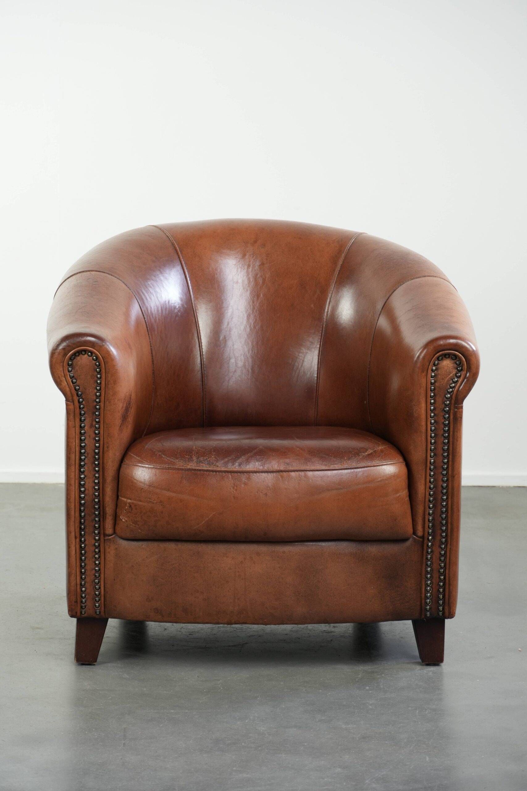 Vintage sheepskin club armchair in English style with deep colours