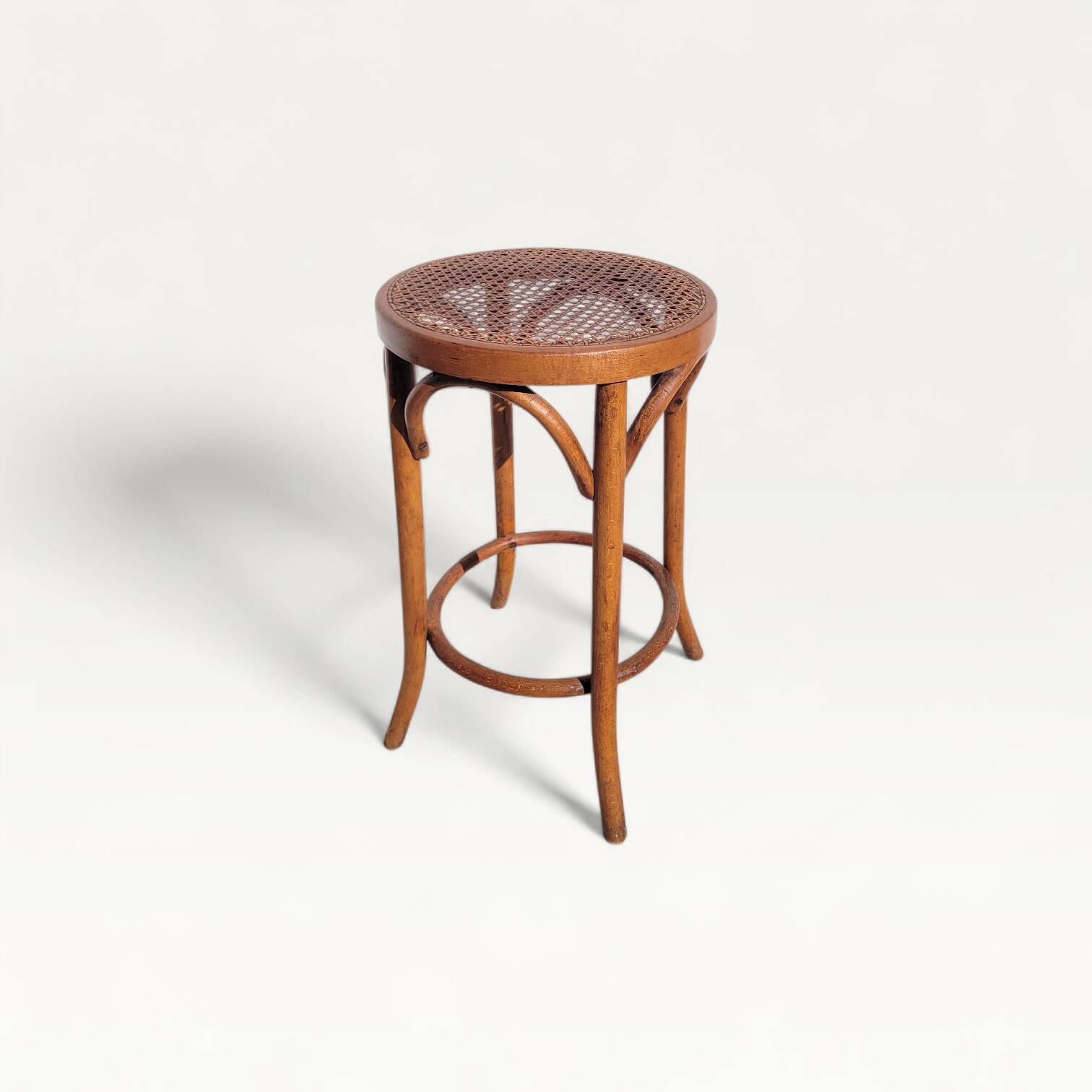 Old low caned bistro stool