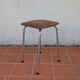 Stool covered in faux leather.