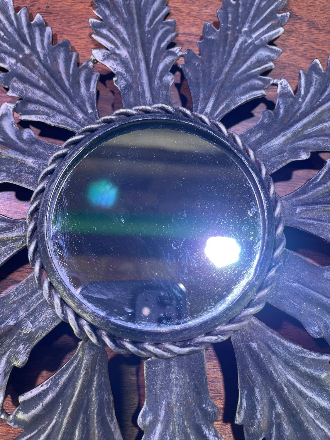 Metal mirror with foliage decoration
