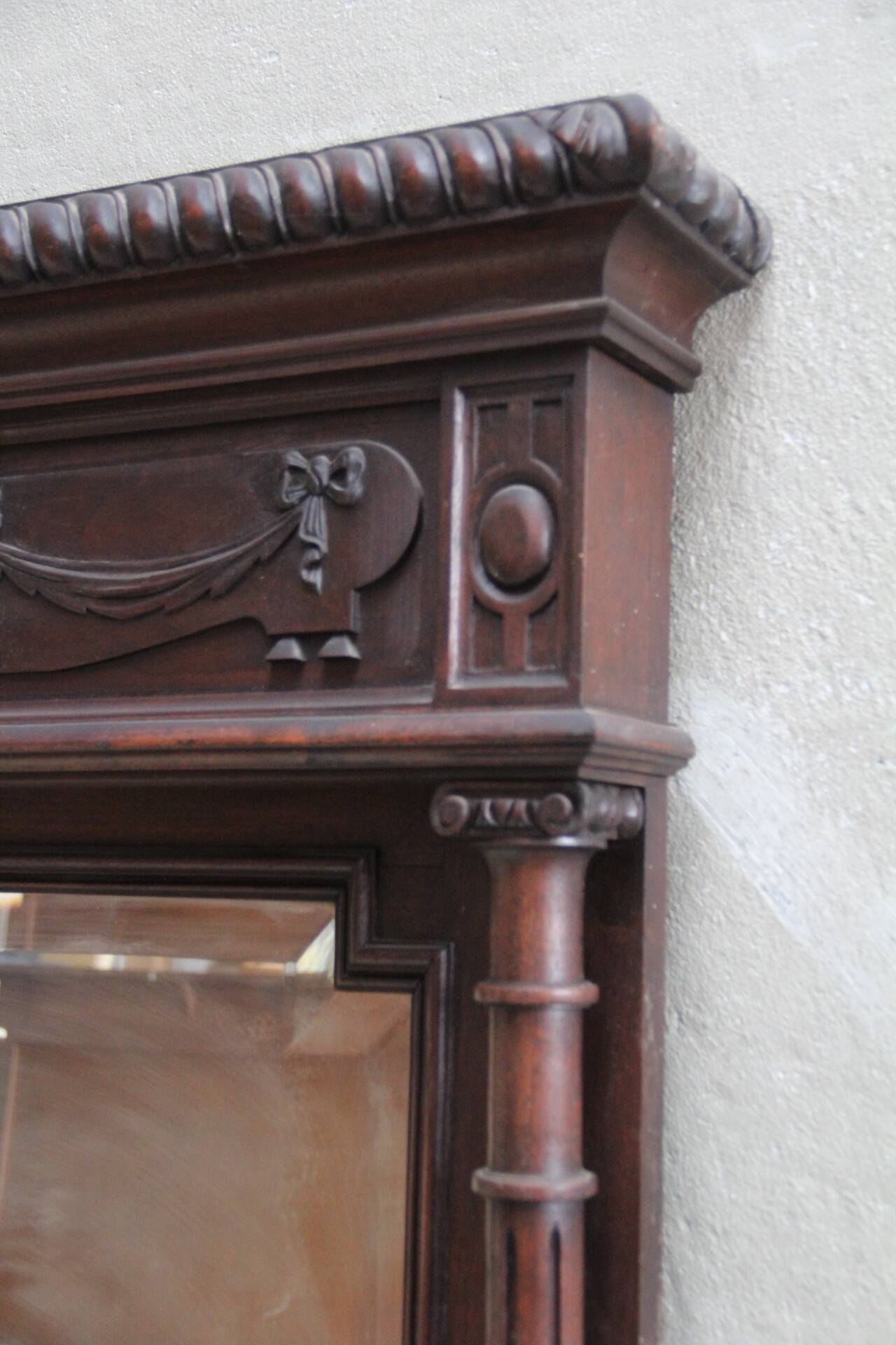 Imposing beveled mirror with wooden frame