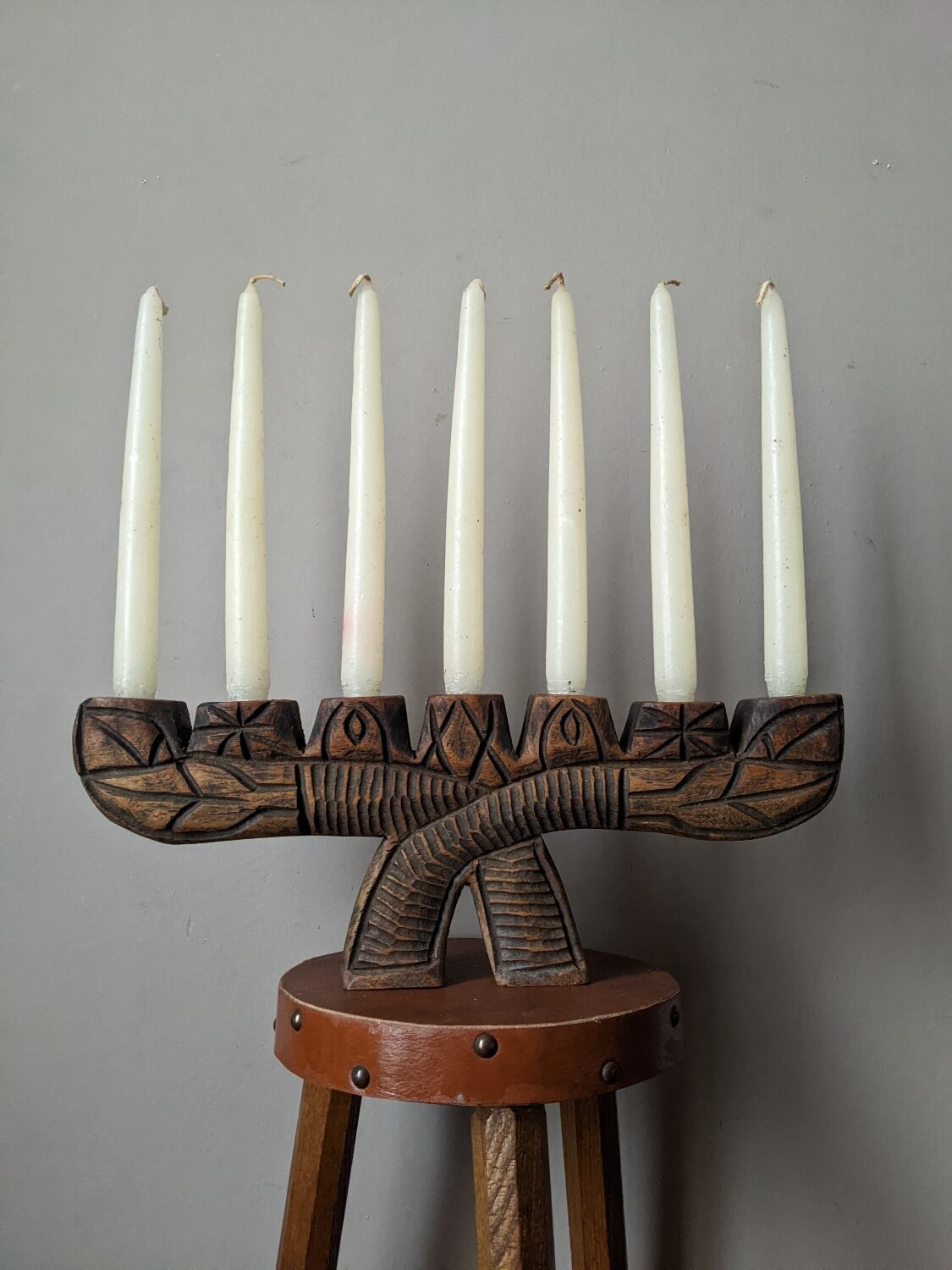 Hand-carved wooden candle holder, ethnic tribal style.