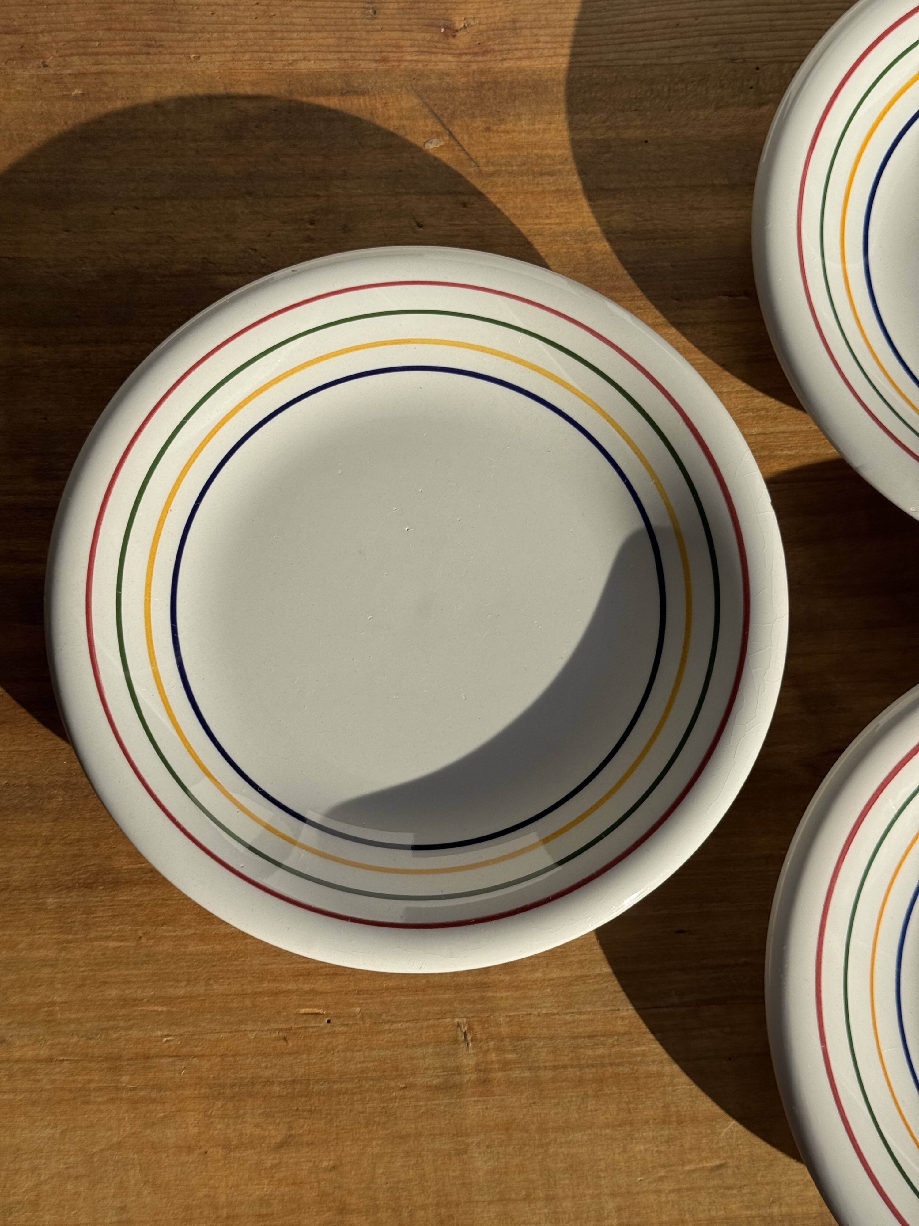 Set of 9 small Italian dessert plates Primula with red and green trim.
