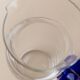 Vintage glass pitcher - clear glass with blue handle - Mid-Century design from Italy in the 1970s - elegant table decoration, retro gift idea.