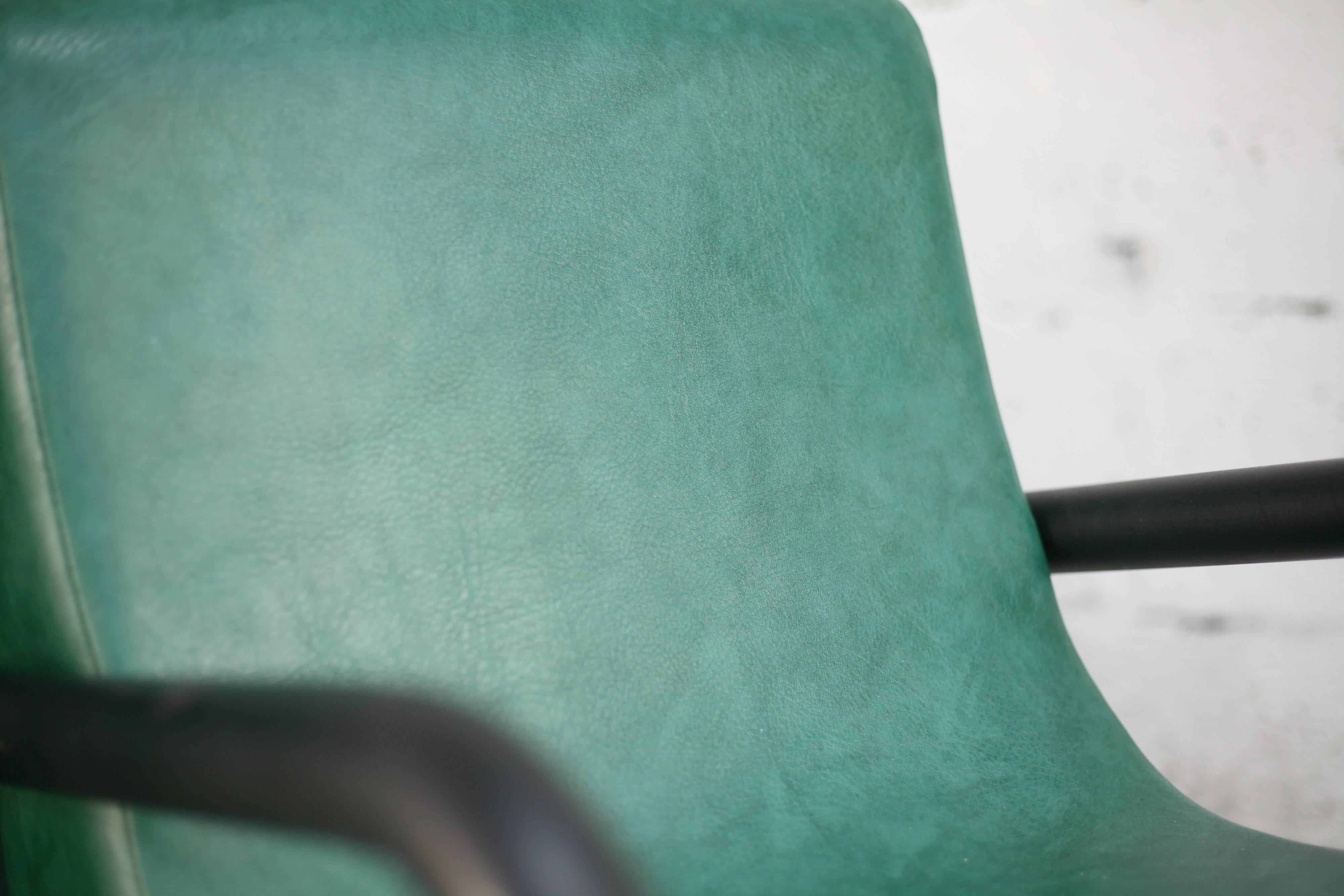 Pair of armrest heaters. Steel and green imitation leather. France, circa 1980