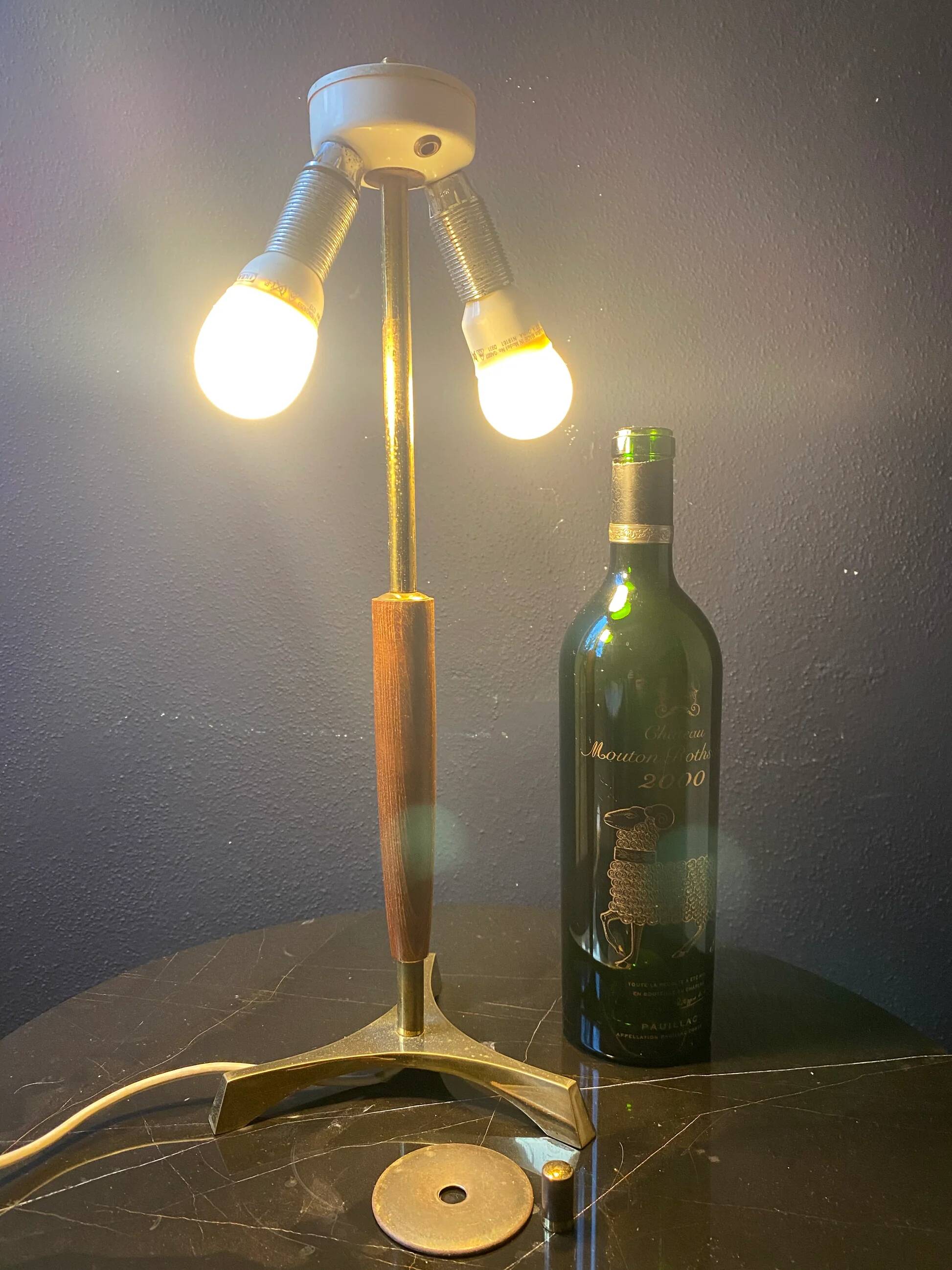 Elegant table lamp with a slender teak body on a tripod brass base, Germany, 1960s.