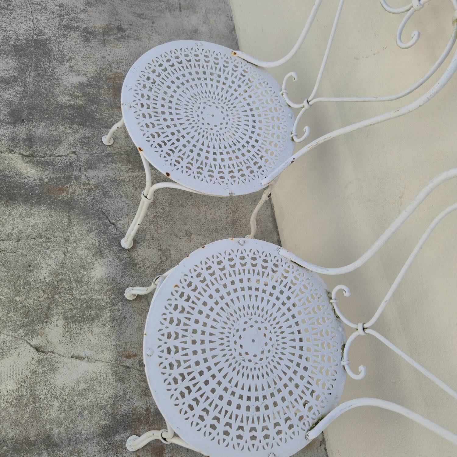 Pair of wrought iron garden chairs, antique manufacture