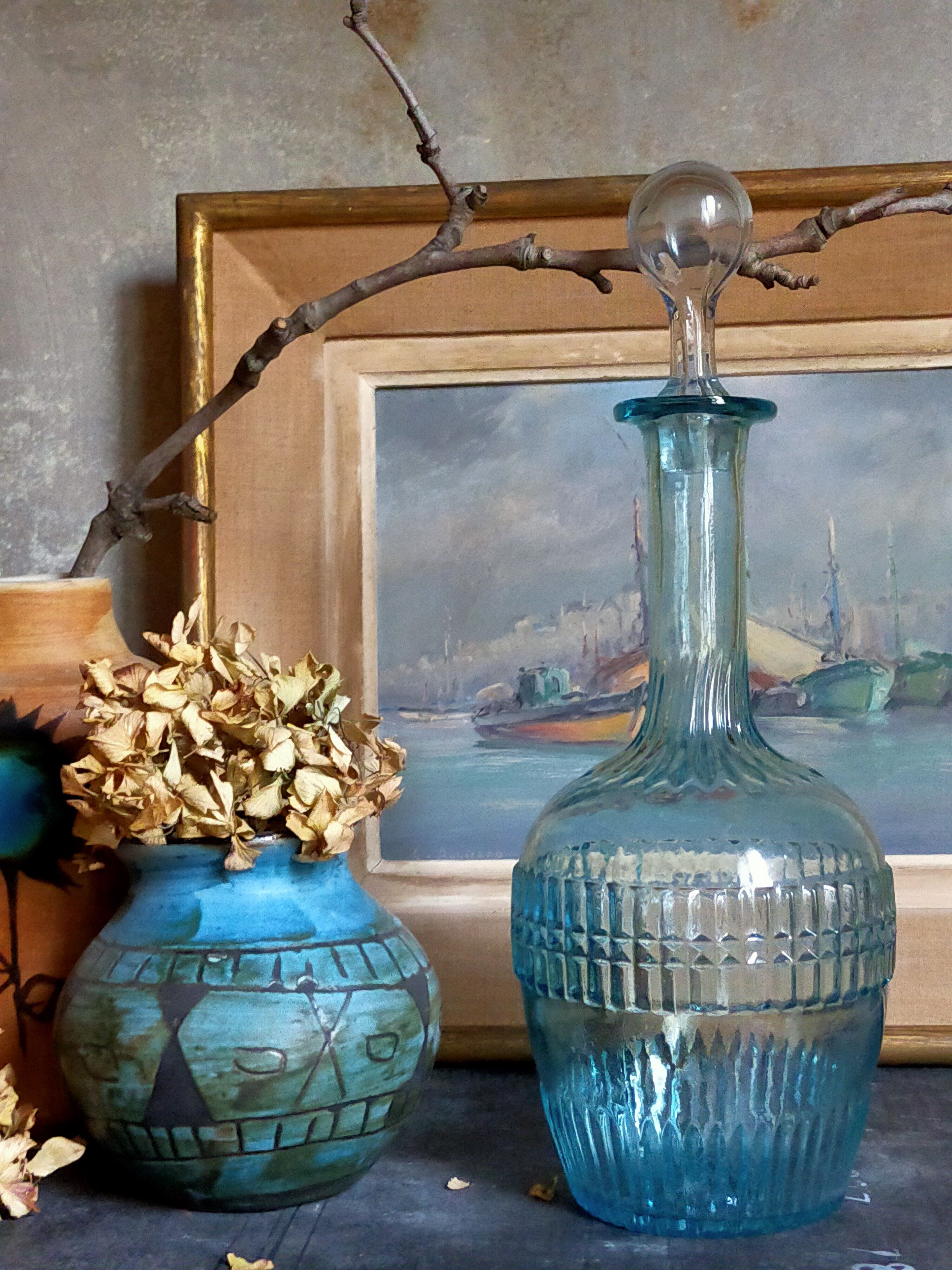 Blue glass carafe with vintage pegs