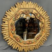 Large wooden mirror with golden sun rays, in Art Deco style.