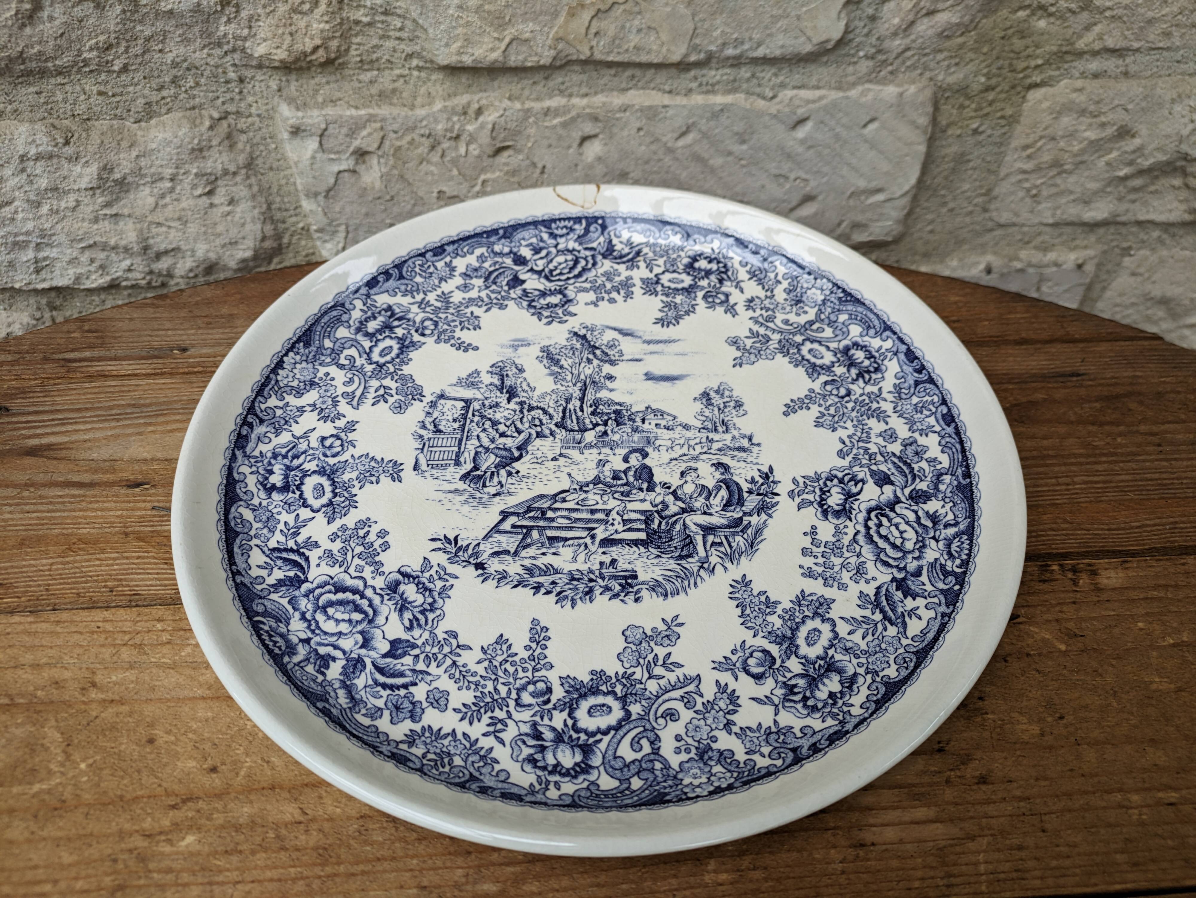 Old ceramic plate with scene of life and blue floral decor Van Melle