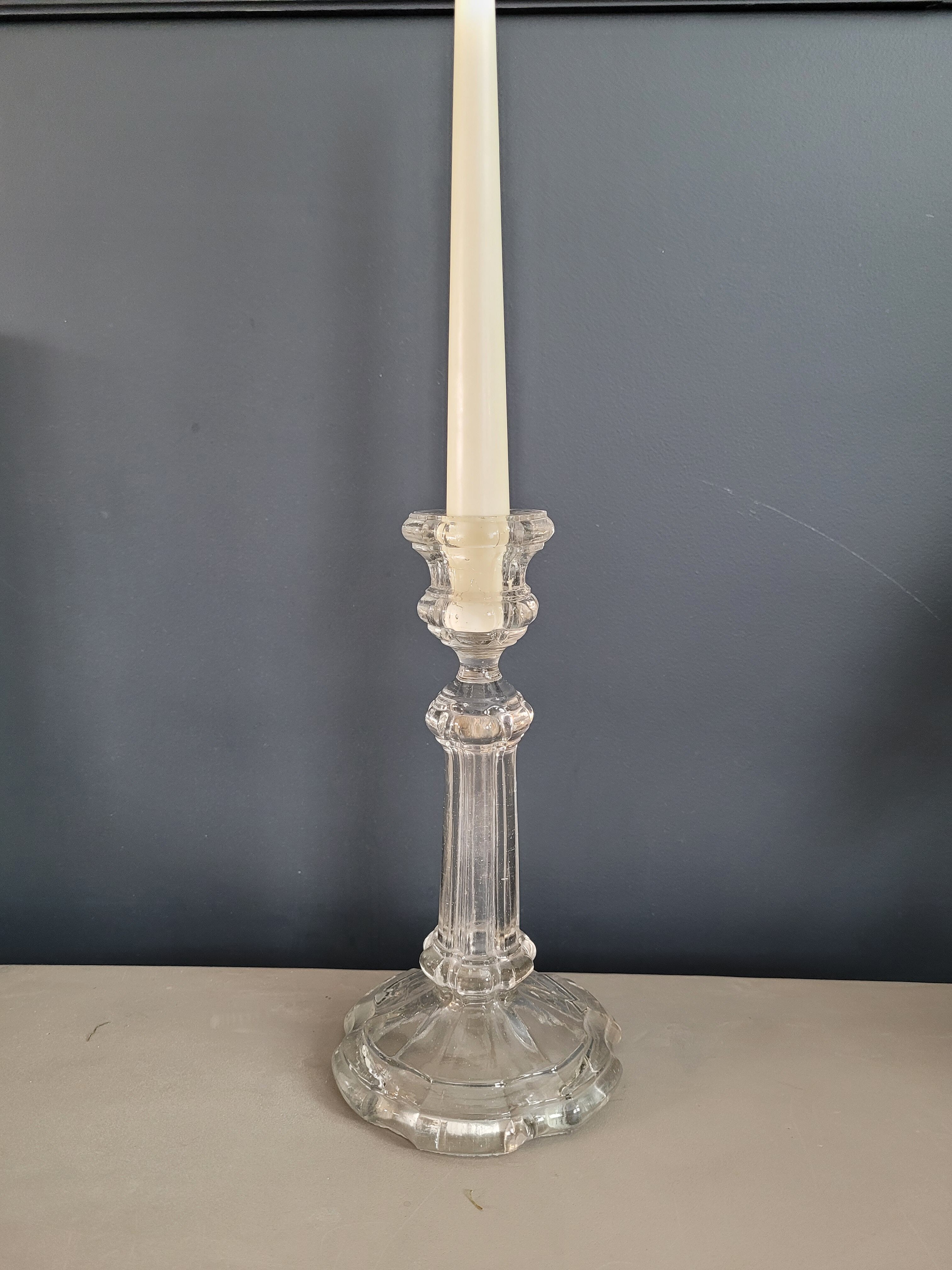 Old candlestick with molded glass stamps