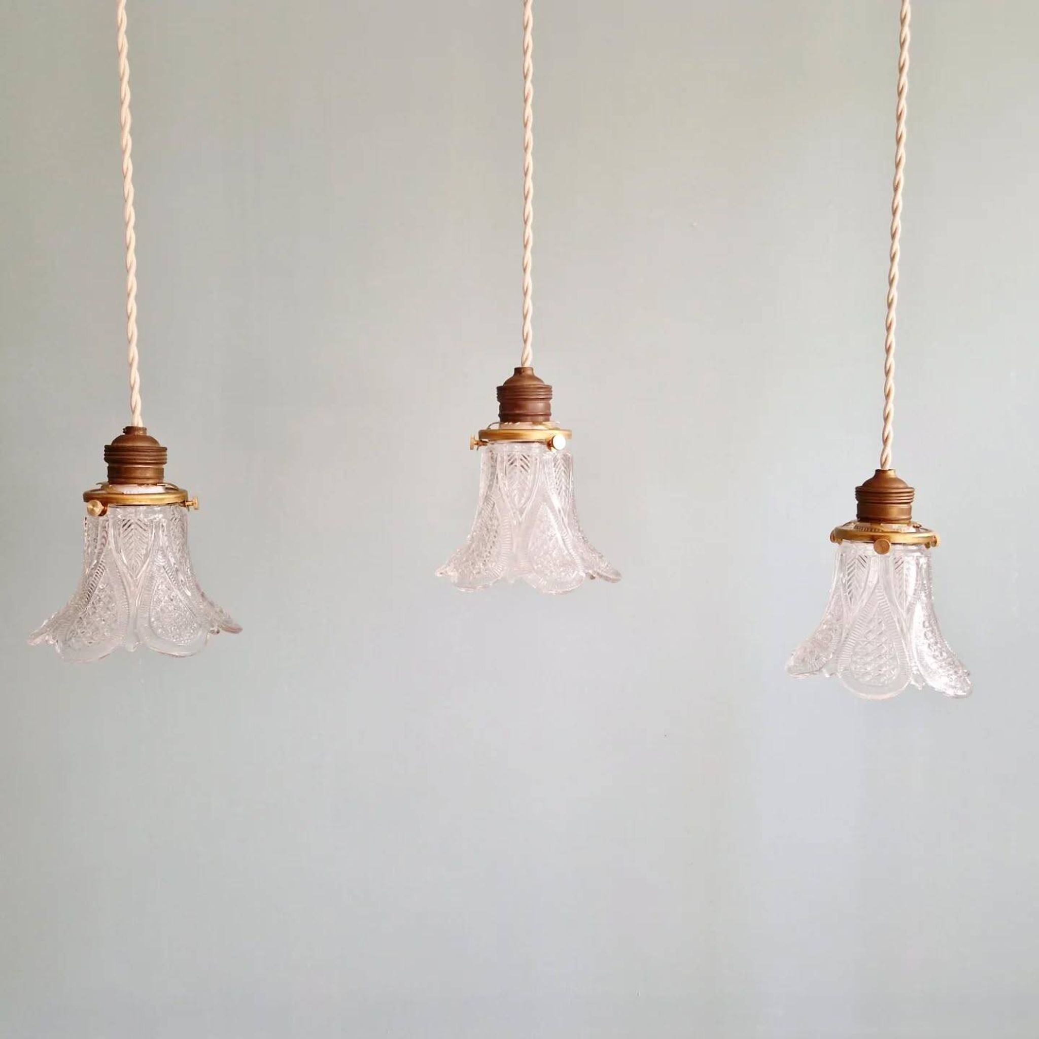Art Deco trio of pendant lights/table lamps in clear glass, 1920s-30s.