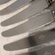 12 silver-plated metal dessert knives with rocaille ribbon decoration, 21.4 cm