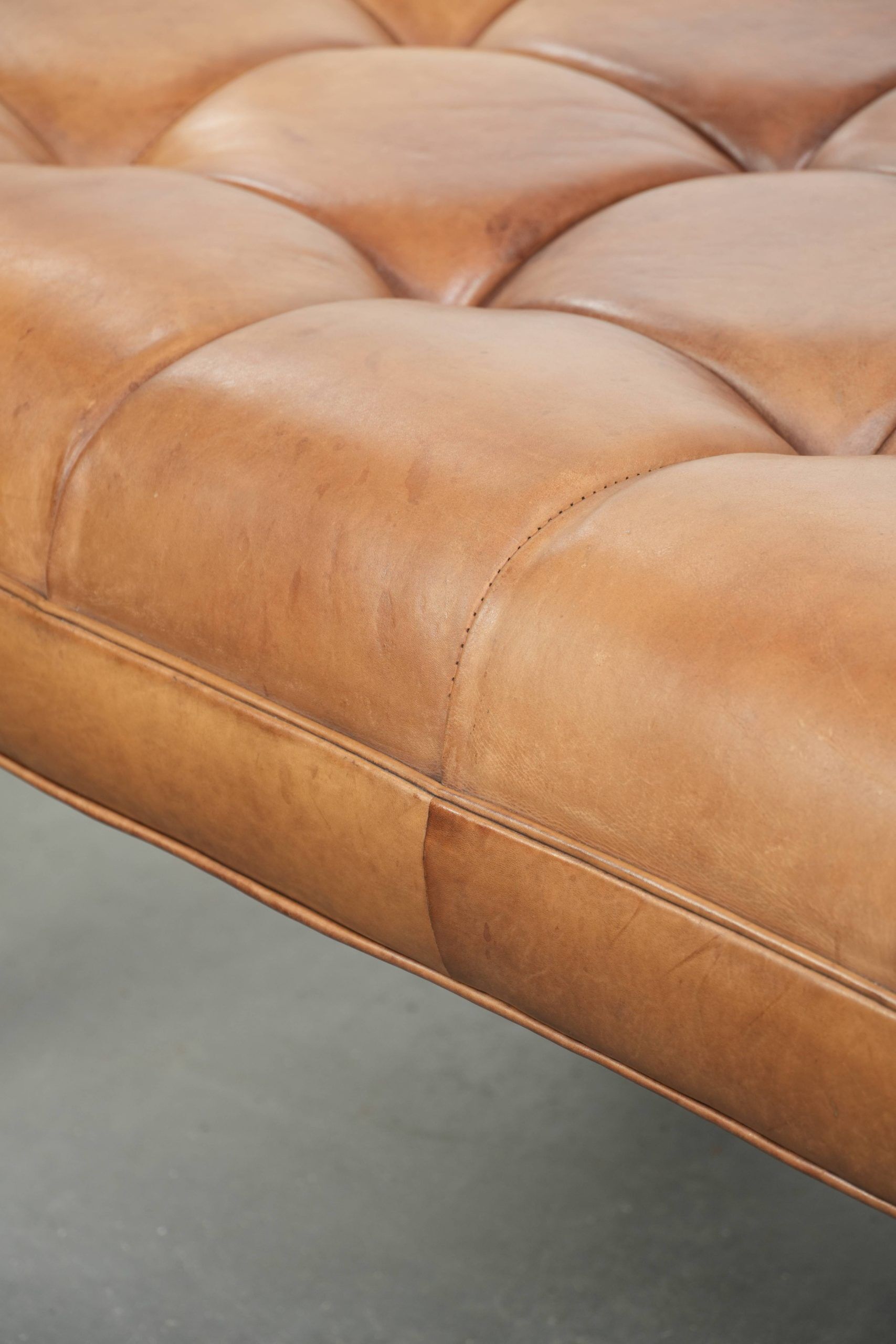 Sheepskin ottoman/coffee table on wheels in English chesterfield style