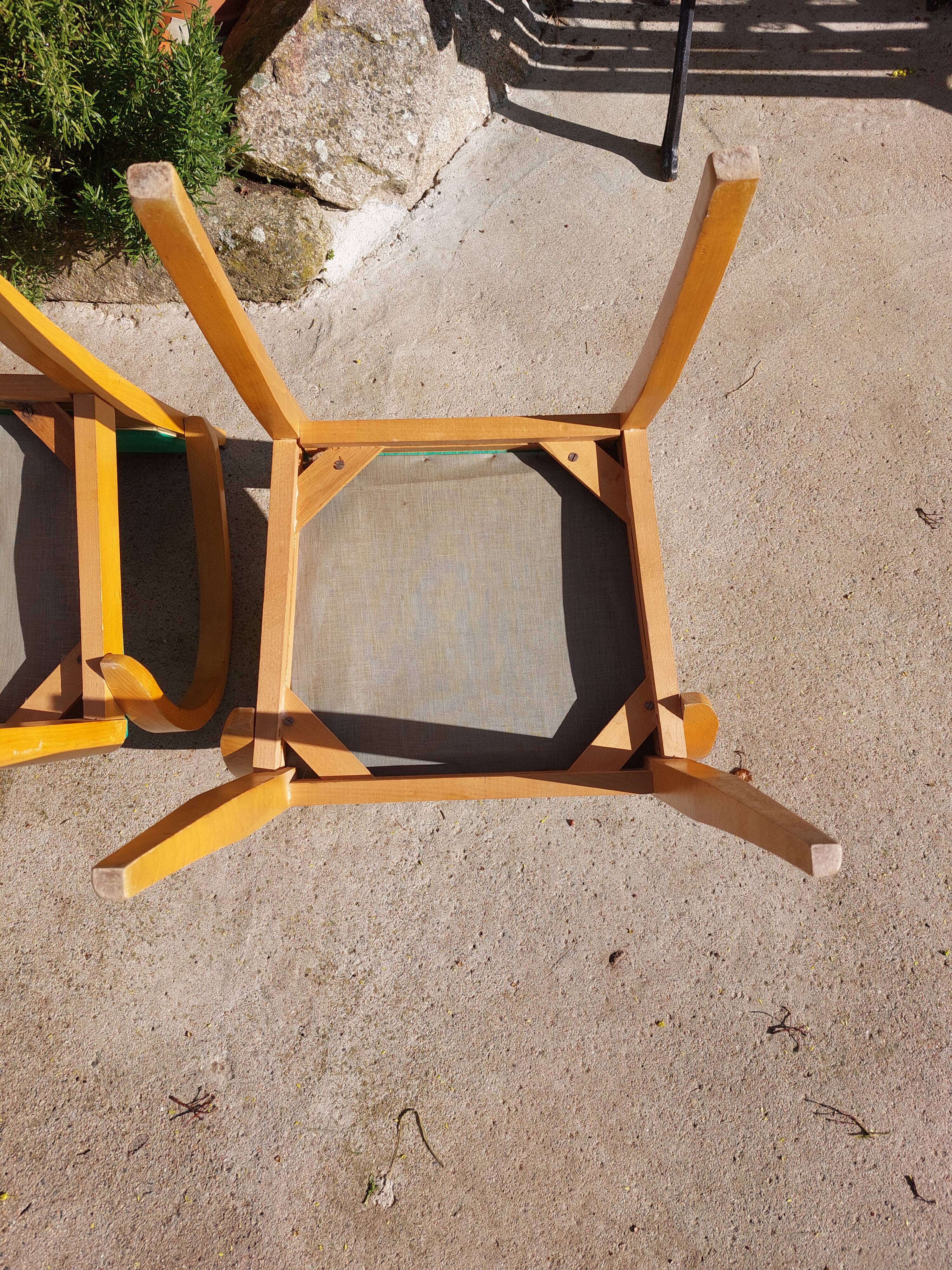 3 vintage bridge chairs with rounded armrests.