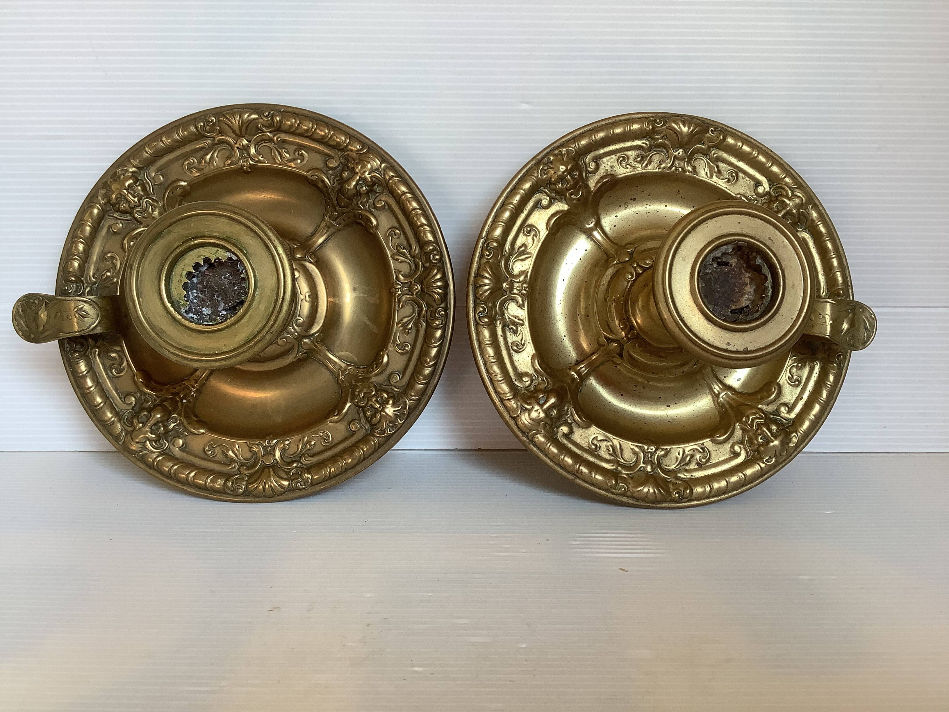 Pair of brass cellar rat candlesticks mascarons