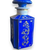 Perfume bottle in porcelain of old paris blue background