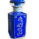 Perfume bottle in porcelain of old paris blue background