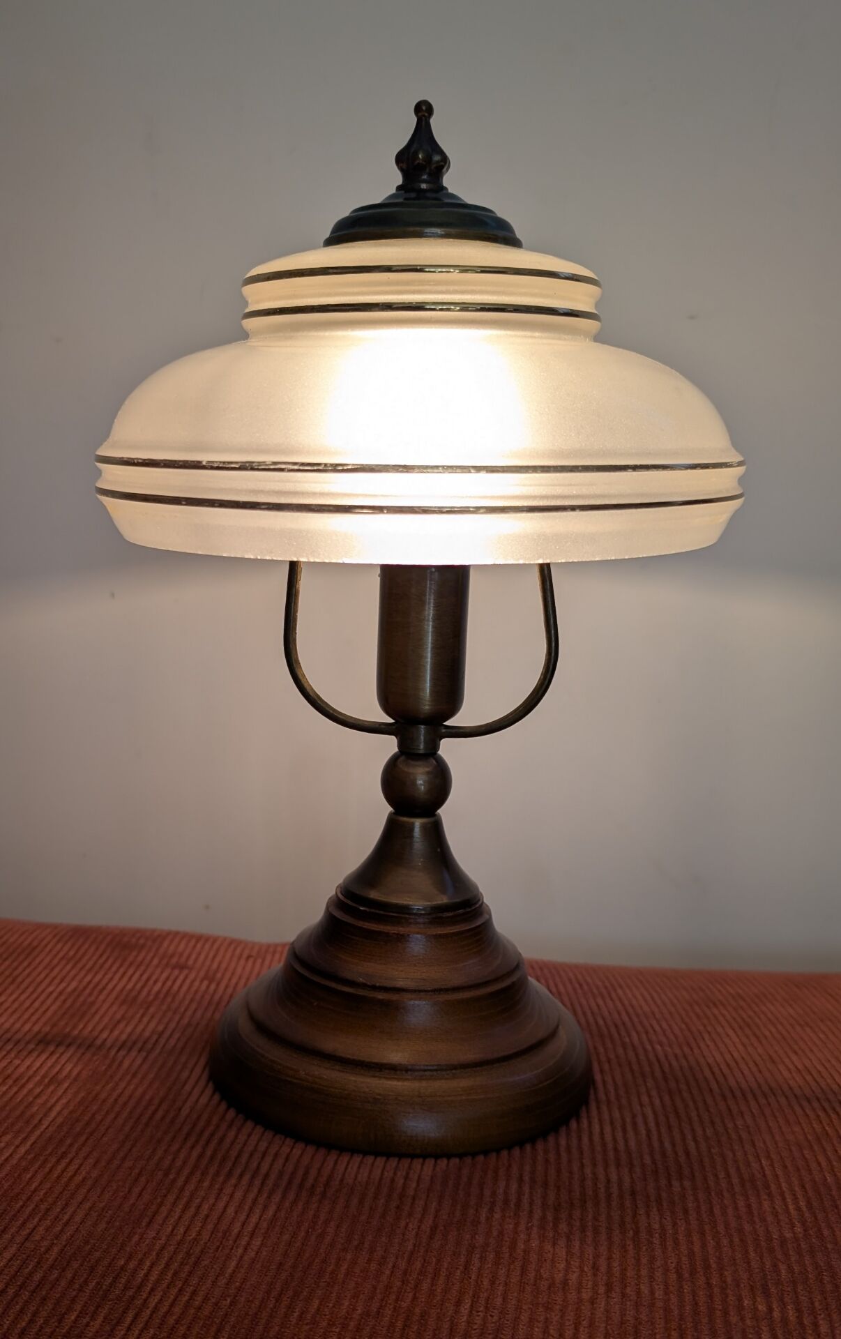 Vintage lamp made of turned wood, brass, and frosted glass.