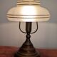 Vintage lamp made of turned wood, brass, and frosted glass.