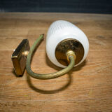Ornate wall lamp made of milk glass and brass