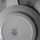 A set of 5 mismatched green blue Terre de fer flat plates