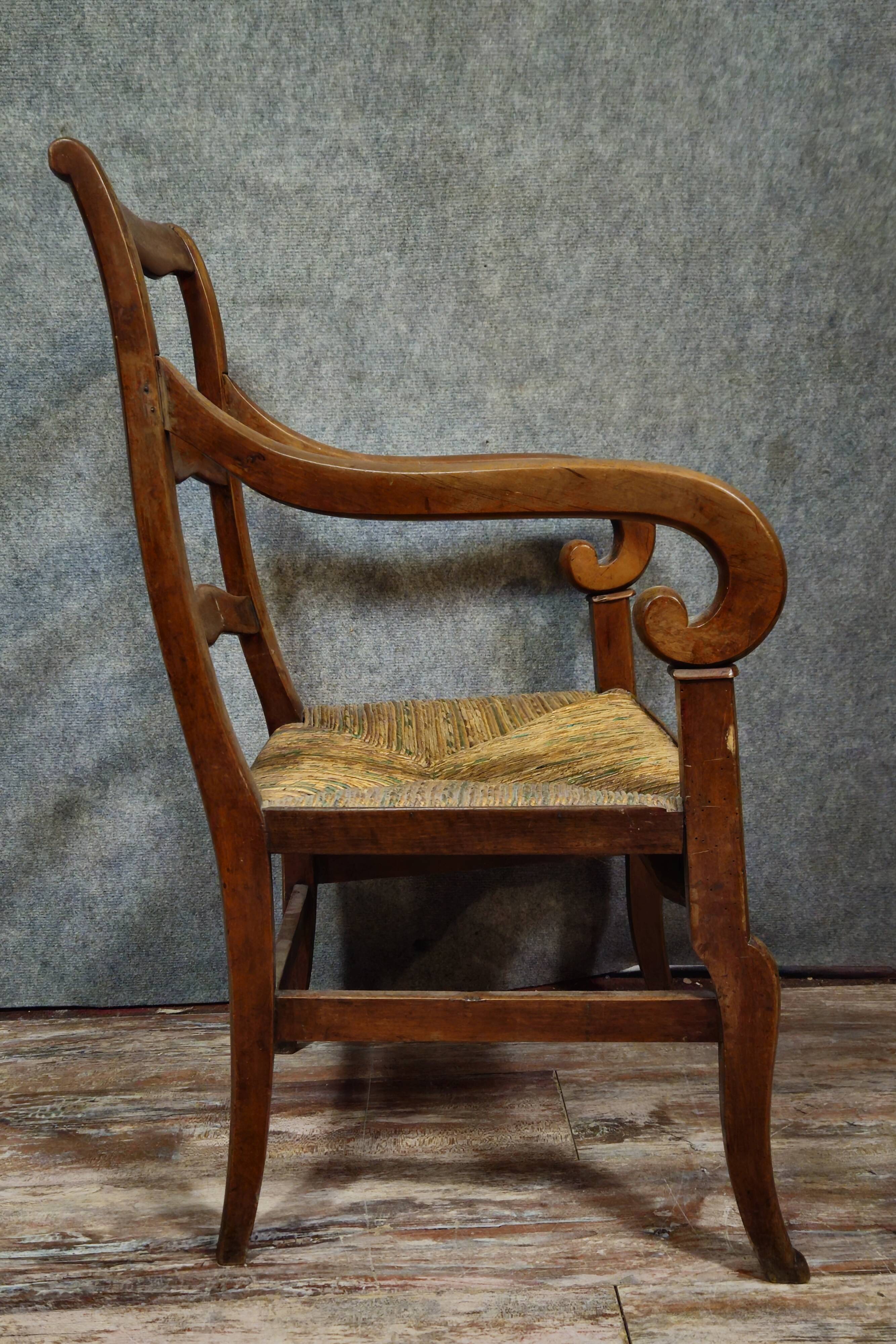 Empire armchair in solid walnut with woven straw seat.