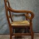 Empire armchair in solid walnut with woven straw seat.