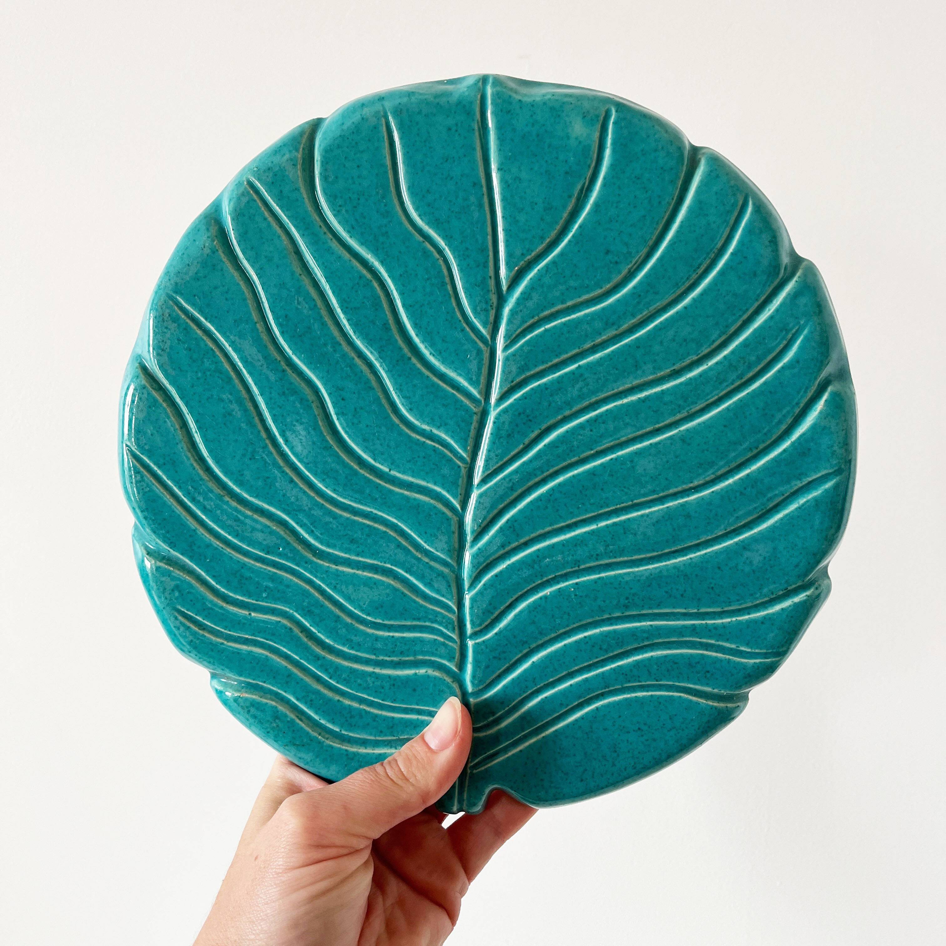 Ceramic trivet and bottle coaster from the 1950s.