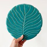 Ceramic trivet and bottle coaster from the 1950s.