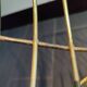 Tubular metal chair covered with gilding