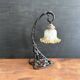 Art Nouveau wall light in wrought iron with vine decoration, early 20th century.