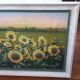 Old oil painting depicting a landscape of sunflowers