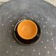 Coffee service composed of 5 cups and saucers in black earthenware and different colored interiors