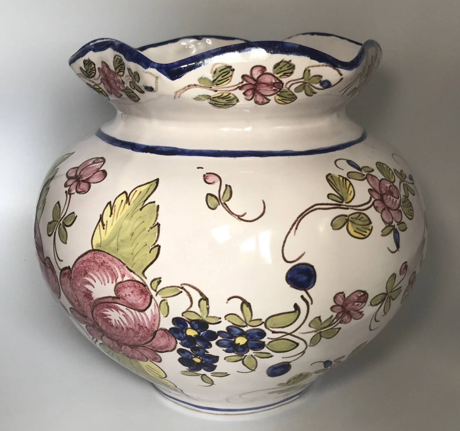 Round earthenware vase with polychrome floral motifs, signed