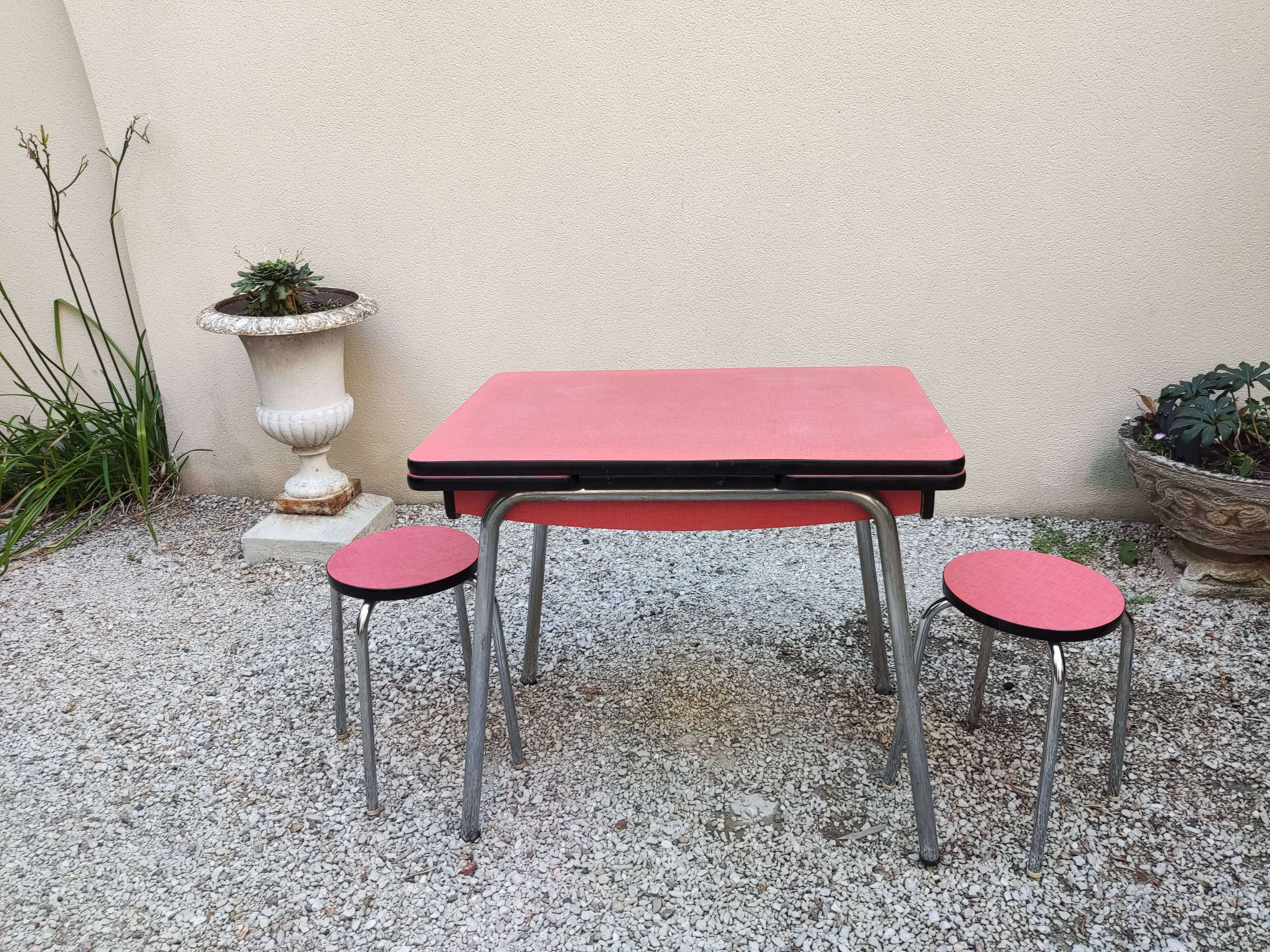 Table with two stools in red formica