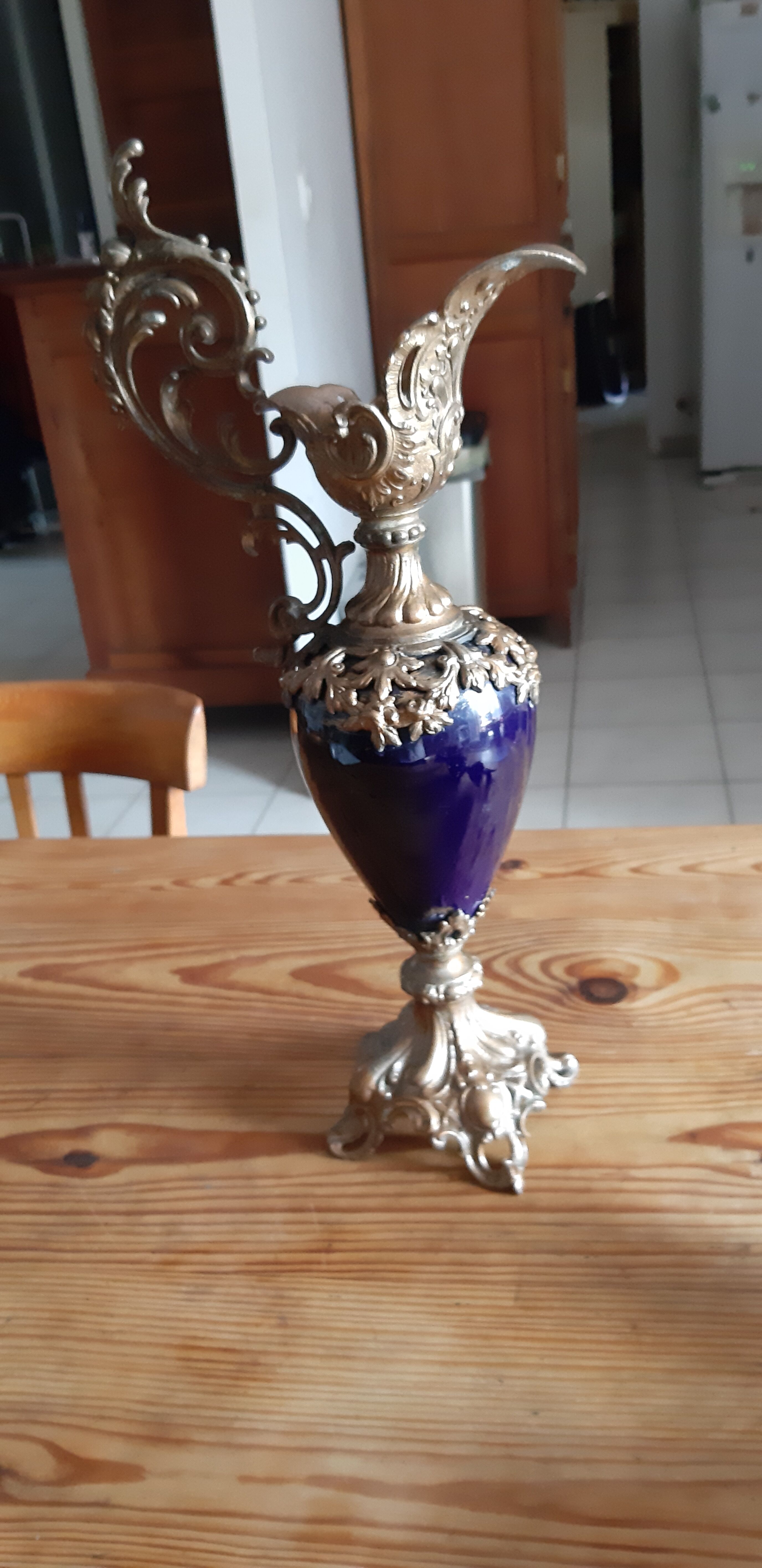 Pair of golden regulated ewers and blue glass