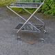 Foldable stainless steel serving trolley with smoked glass tops
