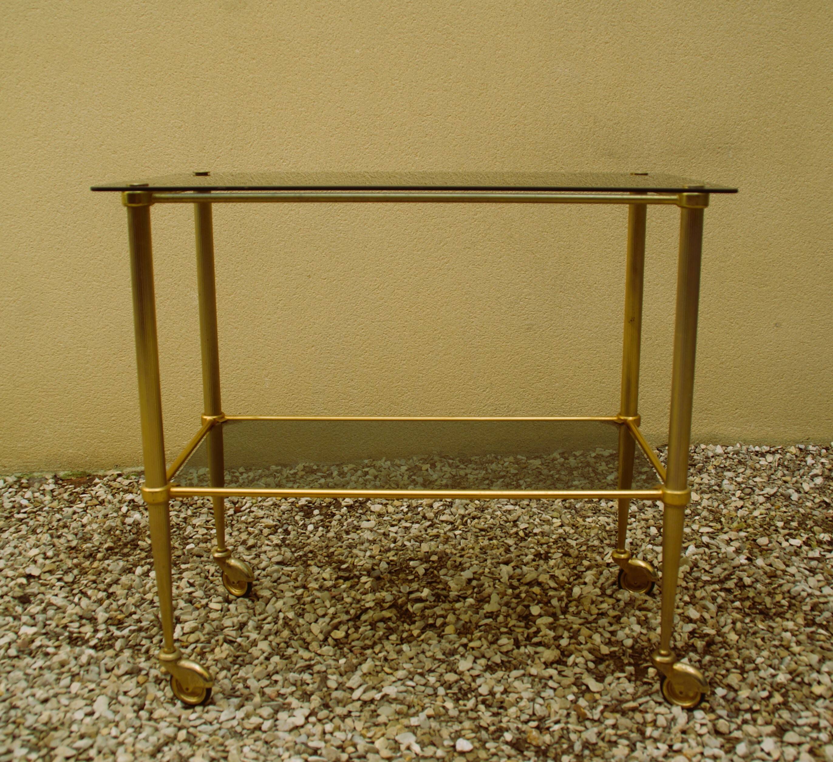 Antique brass serving trolley with smoked glass top, Louis XVI style.