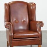 Cognac-colored leather wingback chair in English style
