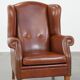 Cognac-colored leather wingback chair in English style