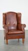 Cognac-colored leather wingback chair in English style