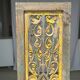Rectangular Indonesian construction element with blue and yellow plant in carved wood