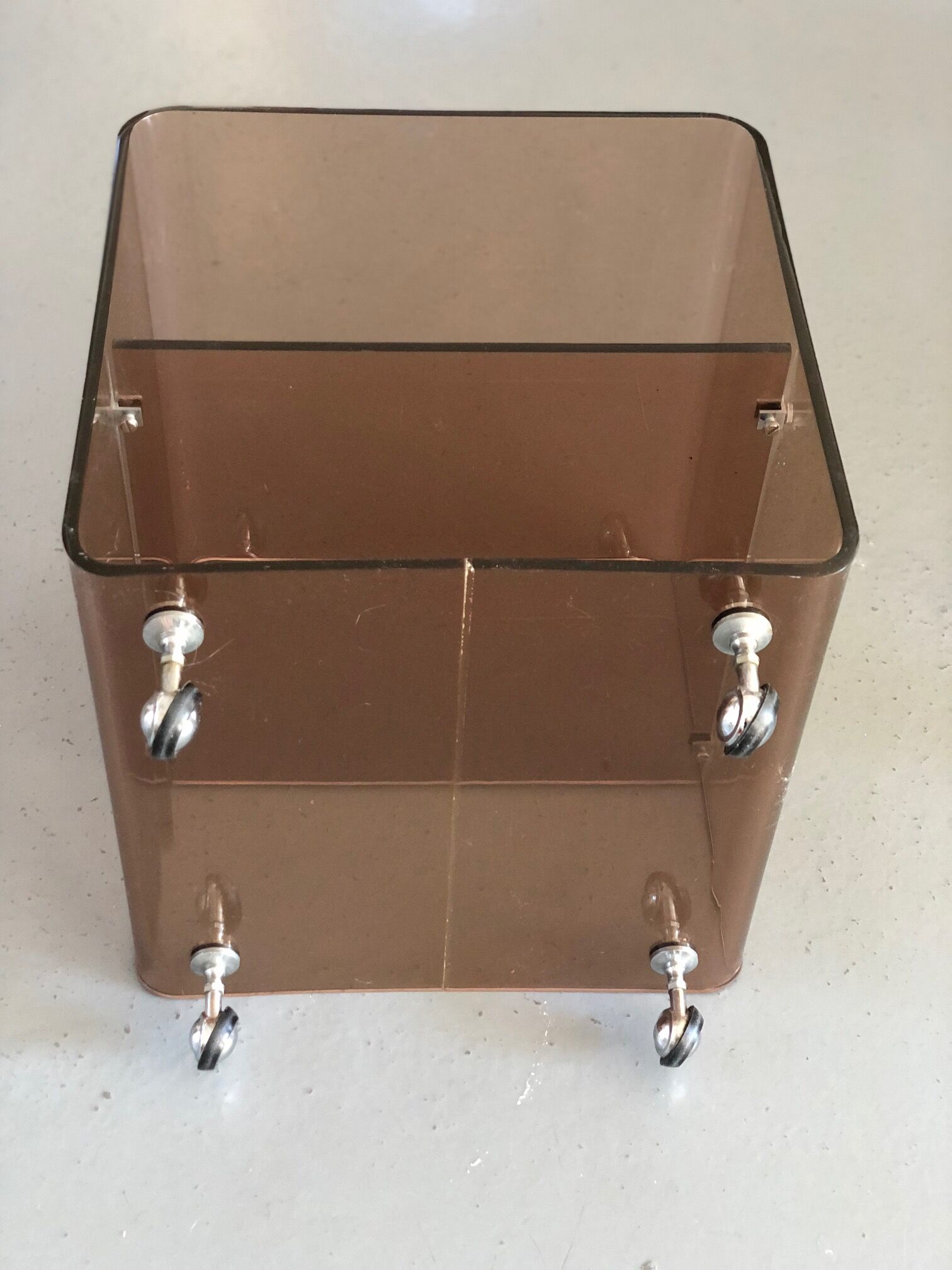Served on wheels in smoked brown plexiglass 70s.
