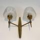 Pair of bronze wall sconces with worked glass reflectors. Stilnovo
